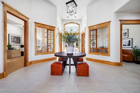 A dining room with a round table and four chairs.
