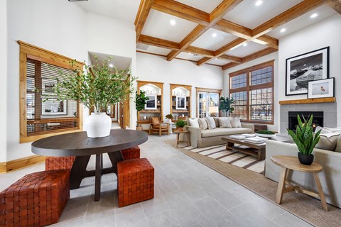 A living room with a large table and a couch.