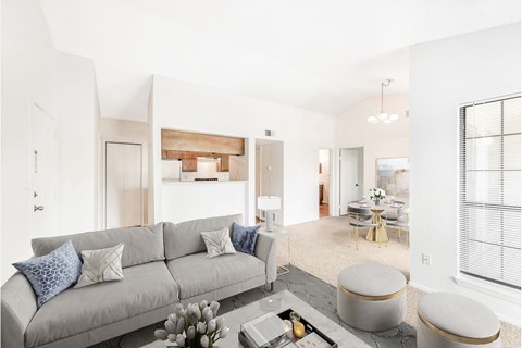 A living room with a grey couch and a coffee table.