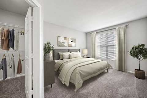 A bedroom with a large bed and a wardrobe with clothes hanging on it.