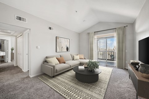 A living room with a grey sofa and a coffee table.