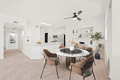 A modern dining room with a round table and chairs.