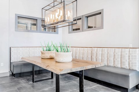 A modern dining area with a wooden table and bench.
