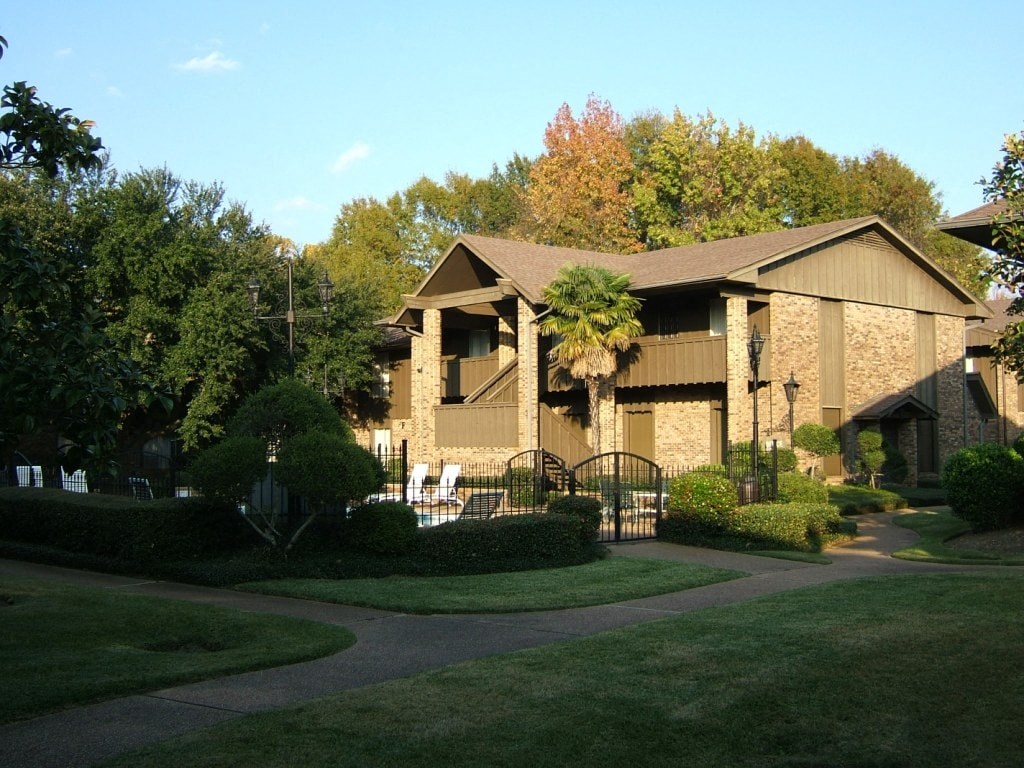a house in a neighborhood with a yard and a gate