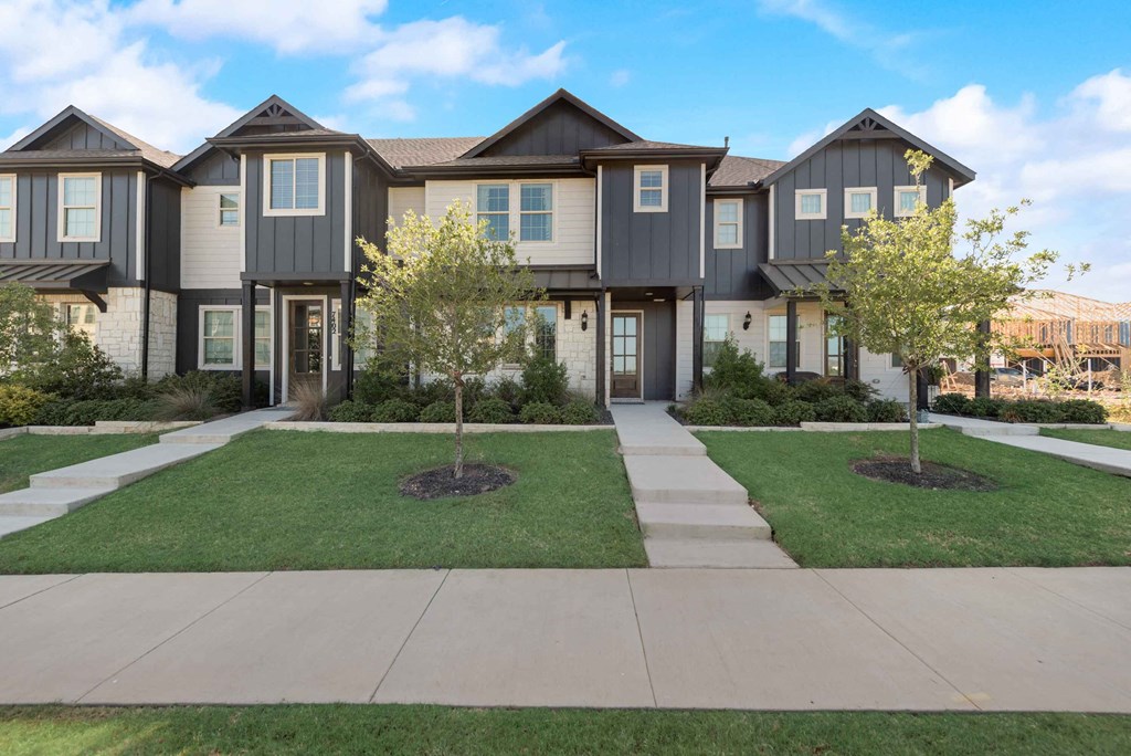 an image of a house with a sidewalk in front of it