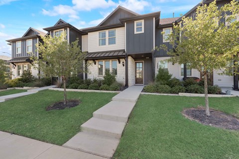 an exterior view of a home with a sidewalk and lawn