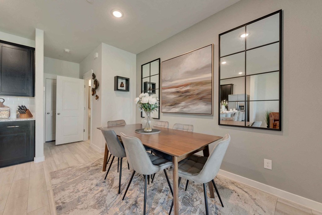 a dining room with a wooden table and chairs