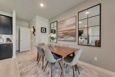 a dining room with a wooden table and chairs