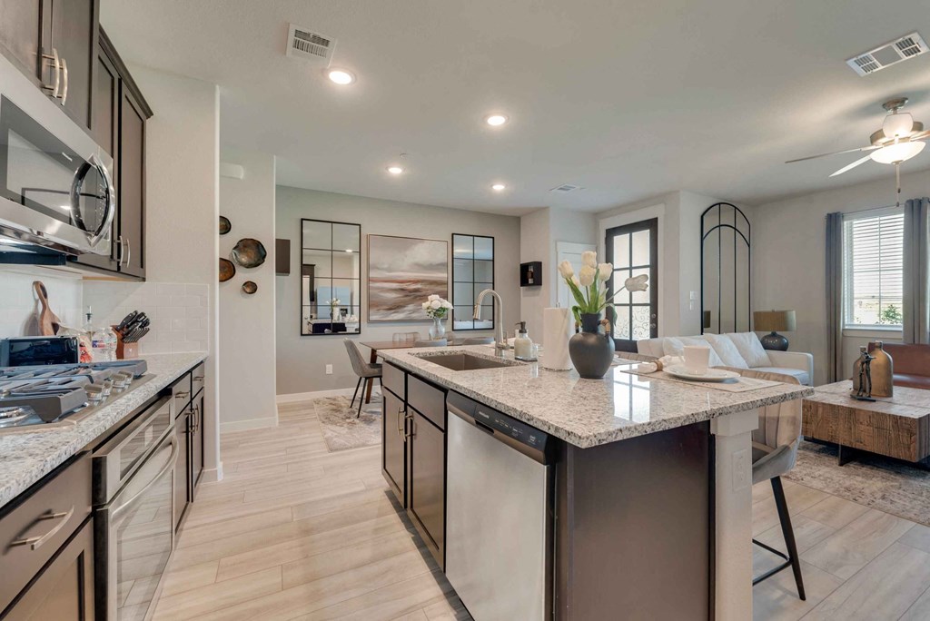 an open kitchen and living room with a counter top