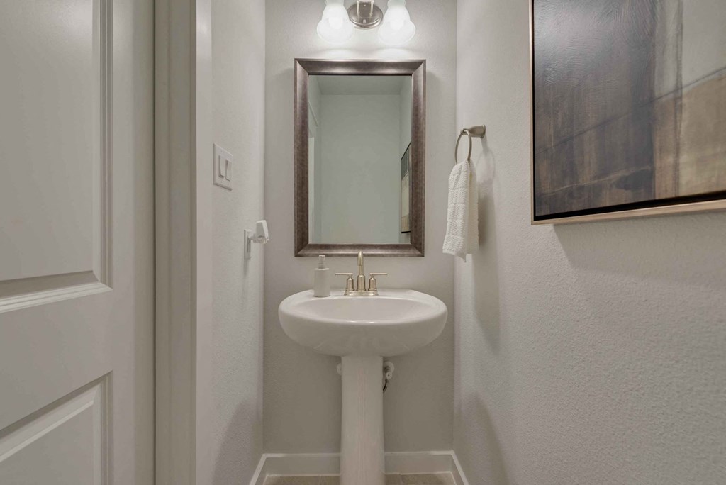 a small bathroom with a sink and a mirror