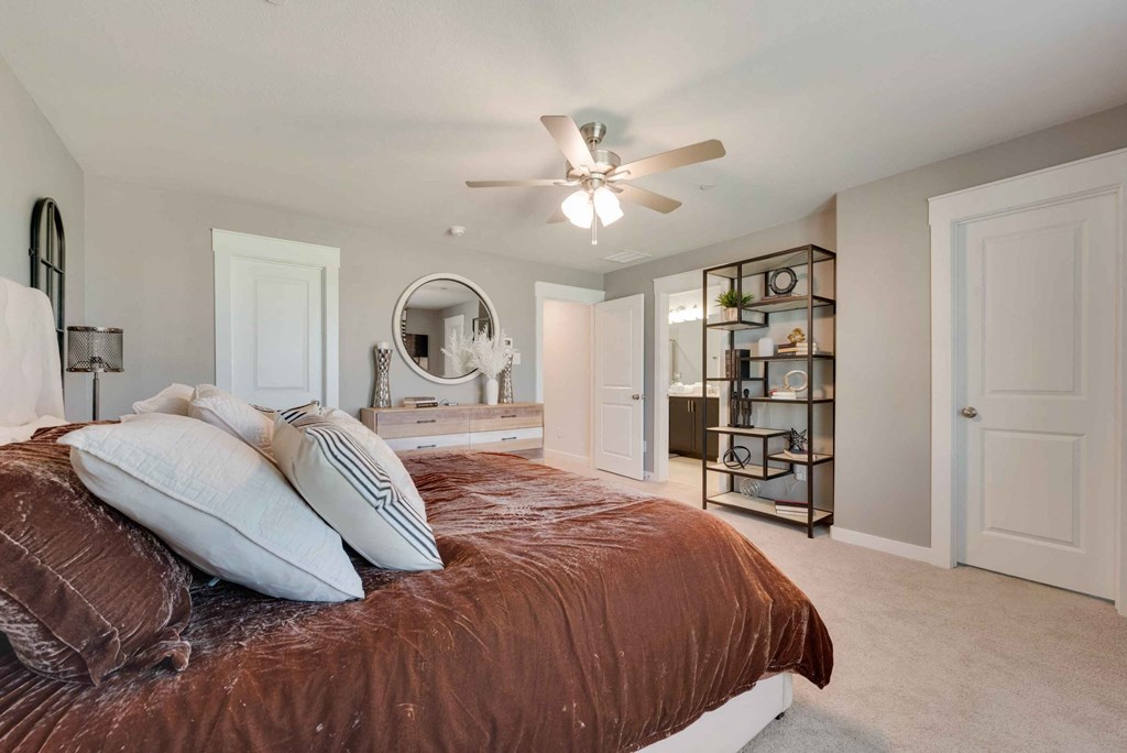 a bedroom with a bed and a ceiling fan