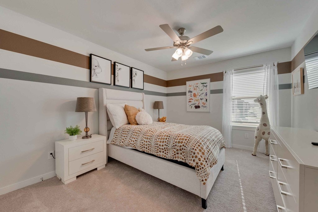 a bedroom with a bed and a ceiling fan