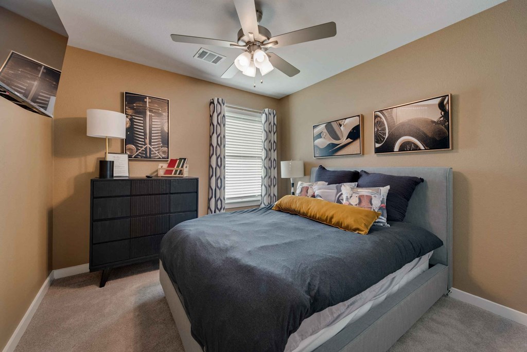 a bedroom with a bed and a ceiling fan