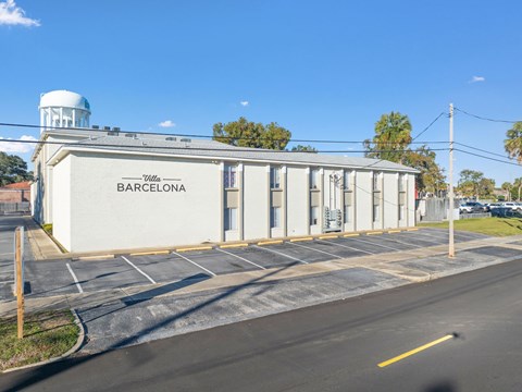Villa Barcelona is a white building with a blue dome in the background.