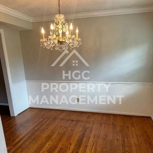 a room with a chandelier and logo