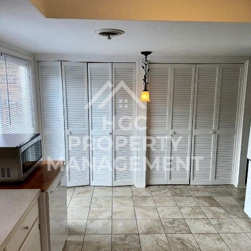 a kitchen with a microwave and a window