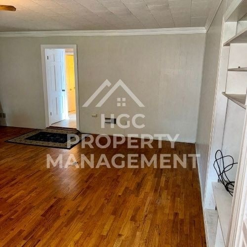a living room with a hard wood floor and a property management