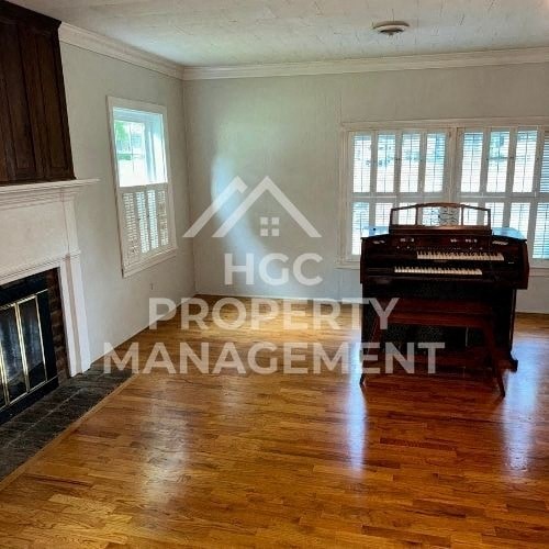 a living room with a piano and a fireplace