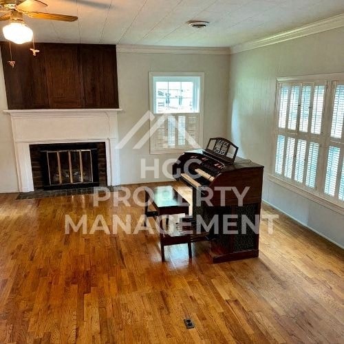 an empty living room with a desk and a fireplace
