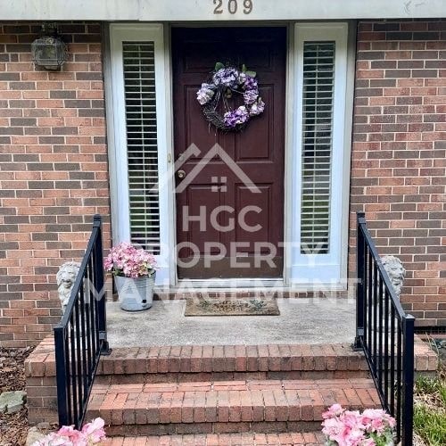 a house with a brown door with a wreath on it
