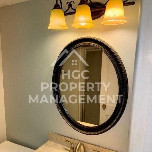 a bathroom with a mirror and some lights on the wall