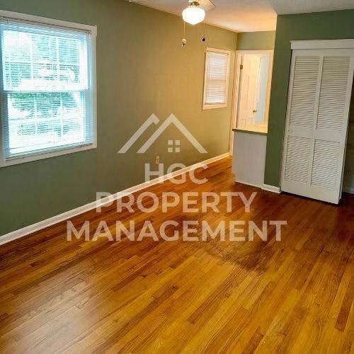 a living room with a hard wood floor and property management