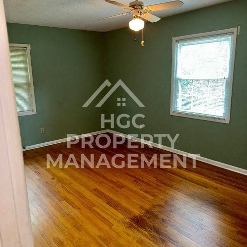 a room with a ceiling fan and a property management