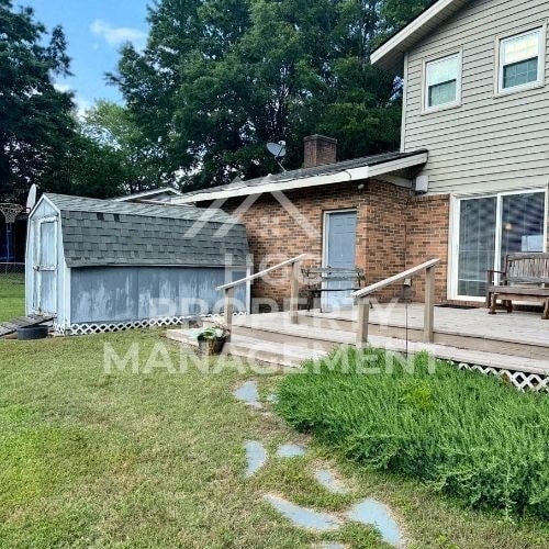 a house with a porch and a shed on the side of it