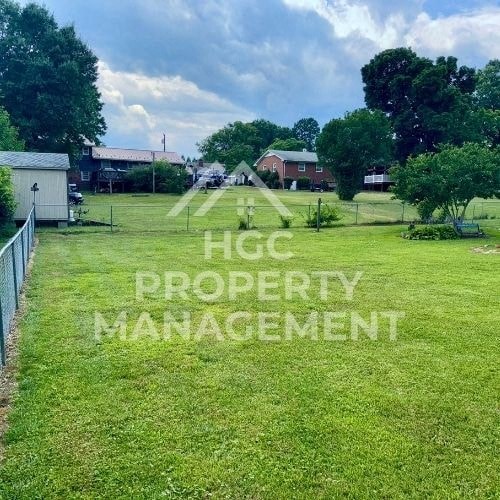 a large field of grass with a fence