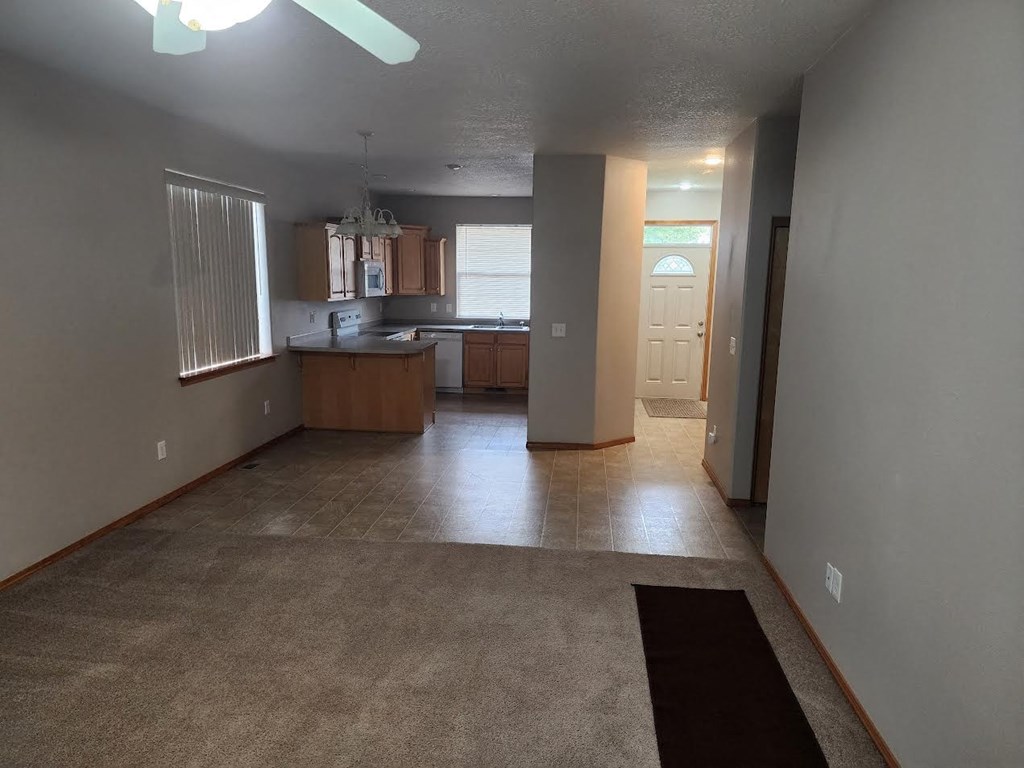 an empty living room and kitchen in a house