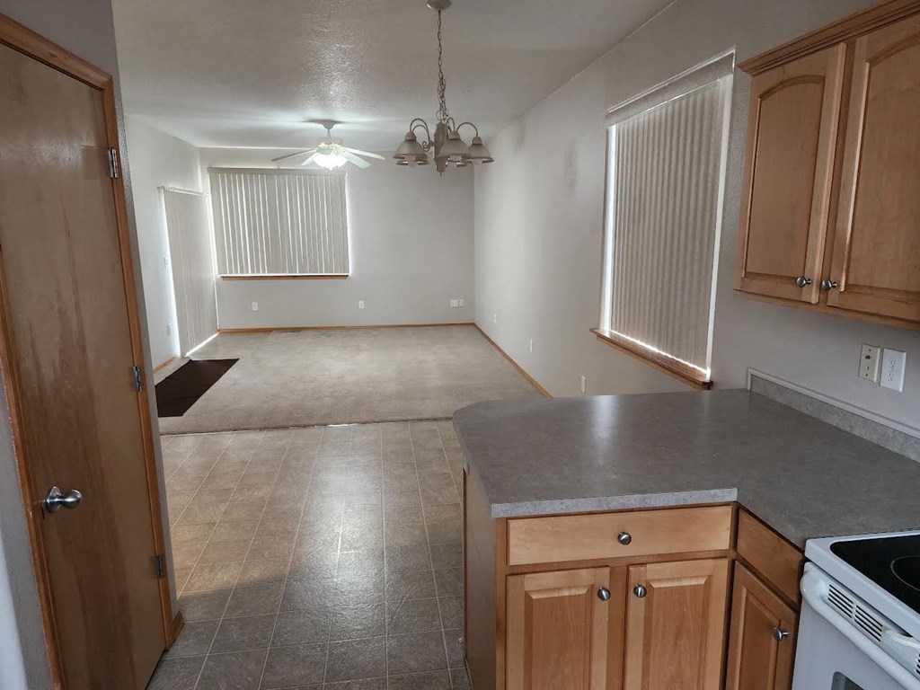an empty kitchen and living room in a house