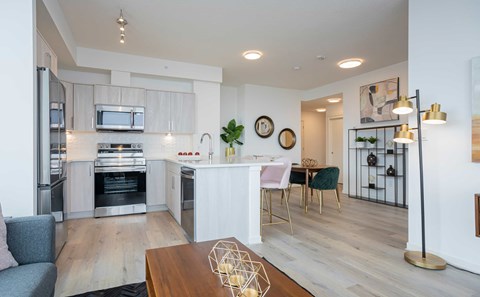 A modern kitchen with a dining table and chairs.