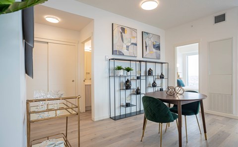 A modern dining room with a round table and chairs.