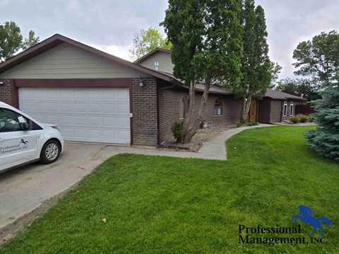 a home with a white car parked in the driveway