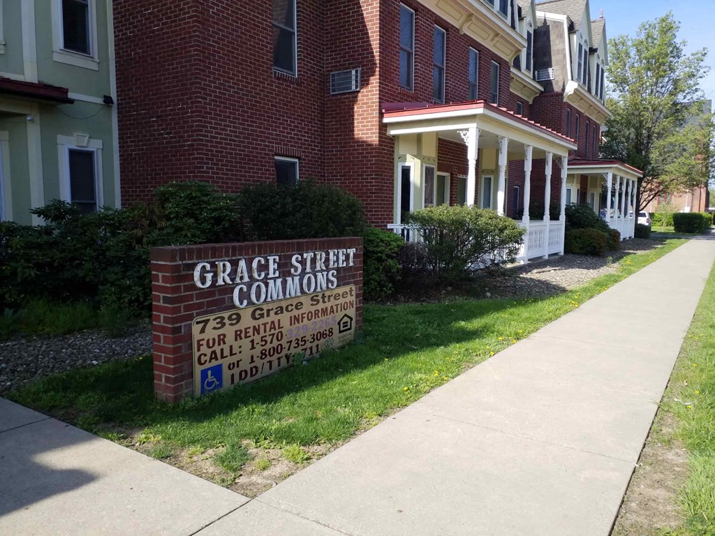 a sign in front of a brick building