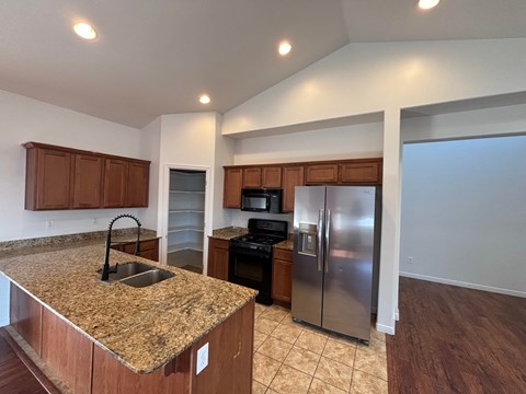 A kitchen with granite countertops and stainless steel appliances.