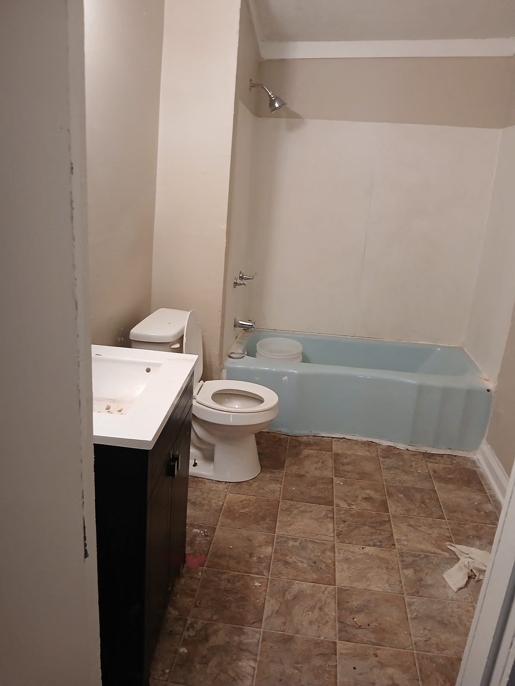 a bathroom with a toilet and a tub and a sink