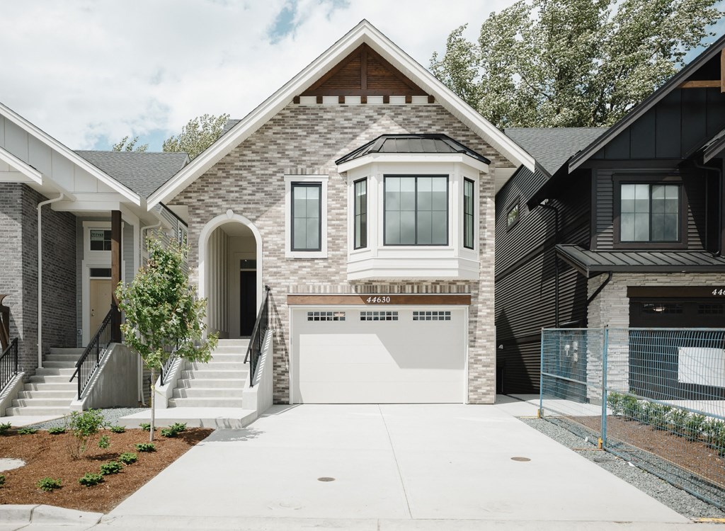 a house with a white garage door in front of it