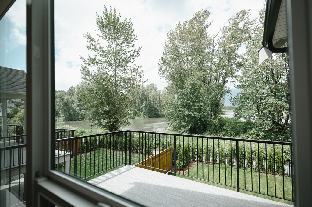 a view of the river from the balcony of a house