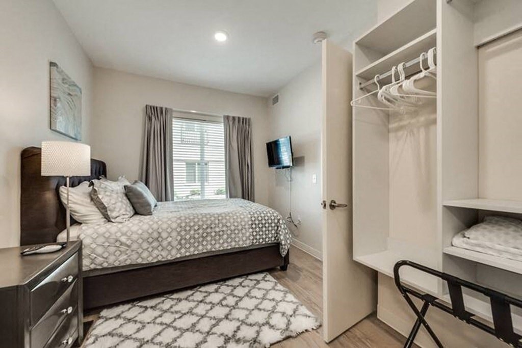 a bedroom with a bed and a closet