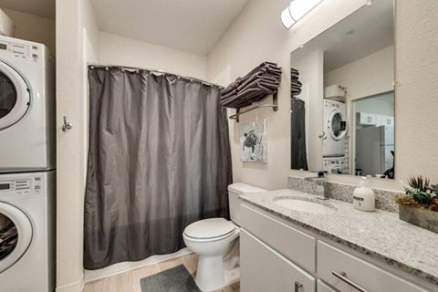 a bathroom with a sink toilet and a washing machine