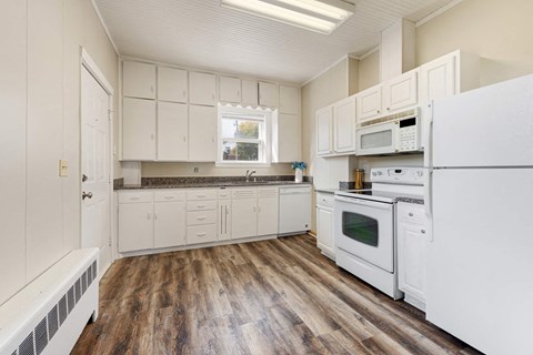 a kitchen with white appliances and white cabinets
