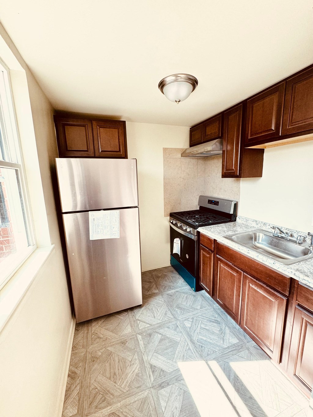 a kitchen with stainless steel appliances and wooden cabinets