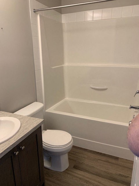 a bathroom with a toilet and a tub and a sink
