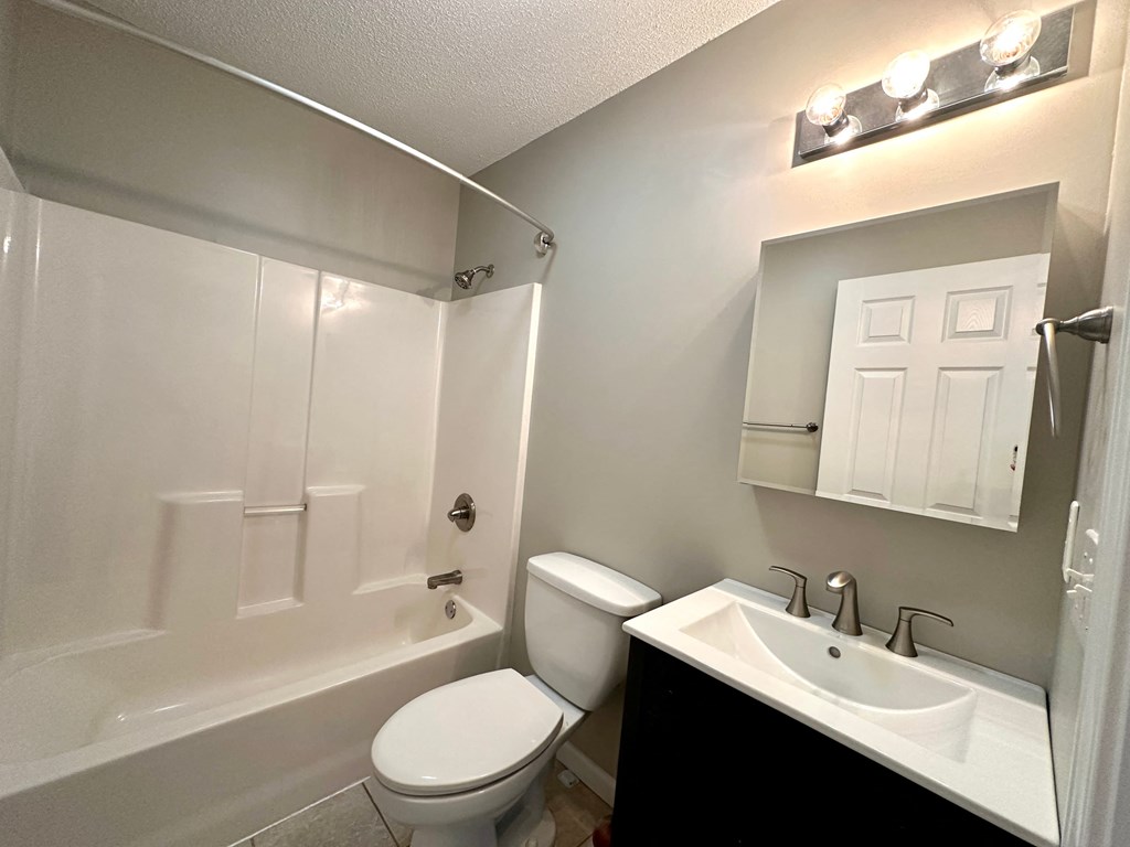 a bathroom with a toilet sink and a shower