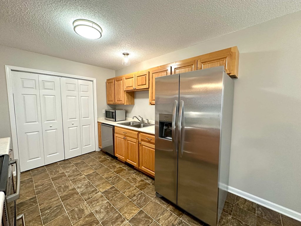 a kitchen with stainless steel appliances and wooden cabinets