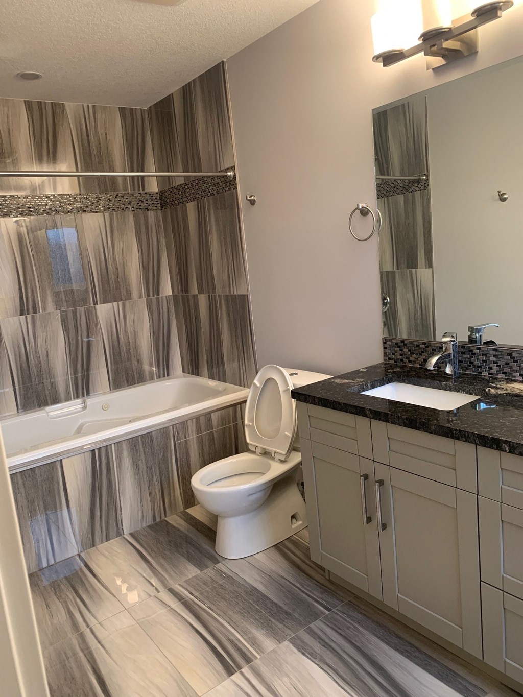 a bathroom with a toilet and a tub and a sink