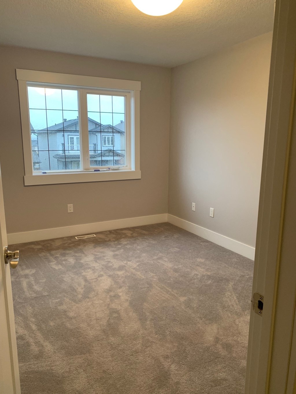 a room with a carpeted floor and a window