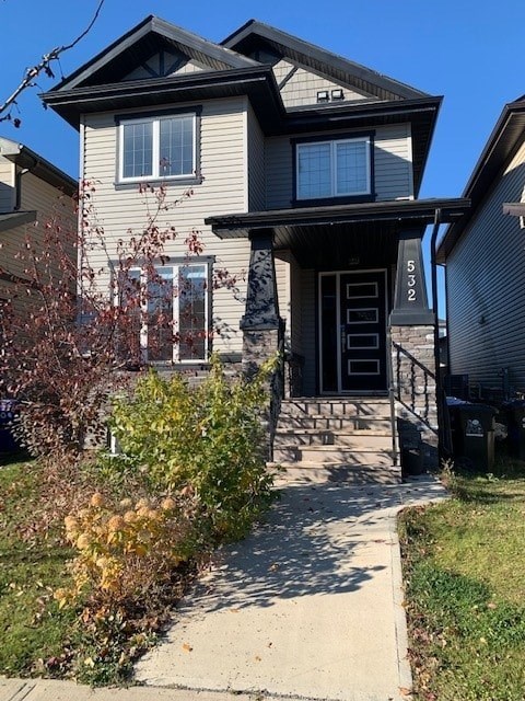 a house with a sidewalk in front of it