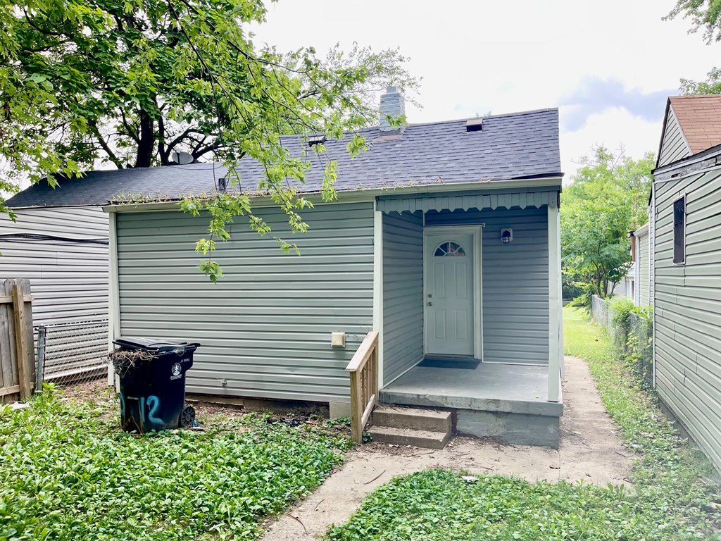 the front door of a small blue house